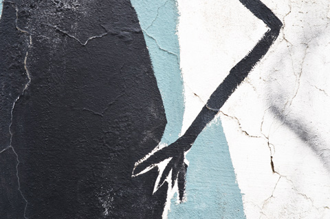 part of a mural of stick figures with oval bodies, a hand on a hip 