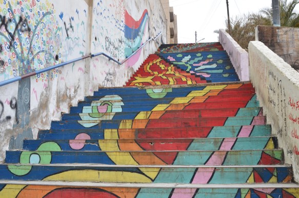 rainow and flowers painted on a set of stairs