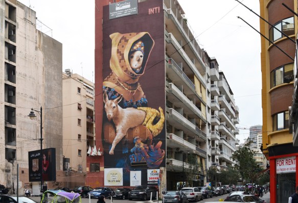 tall Inti mural in Hamras Beirut, of a boy holding onto a goat, boy wearing hooded jacket and a necklace 