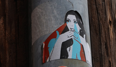 sticker on a pole, woman with laser lights coming out of her eyes,