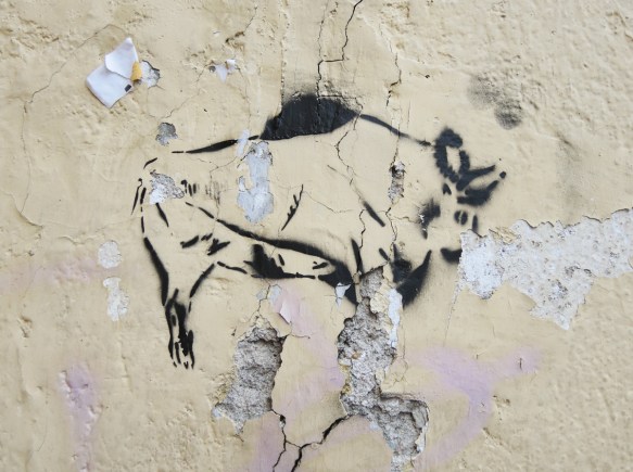 black stencil graffiti of the outline of a bull
