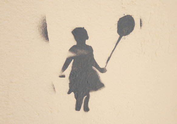 dark grey stencil of a giirl holding a balloon