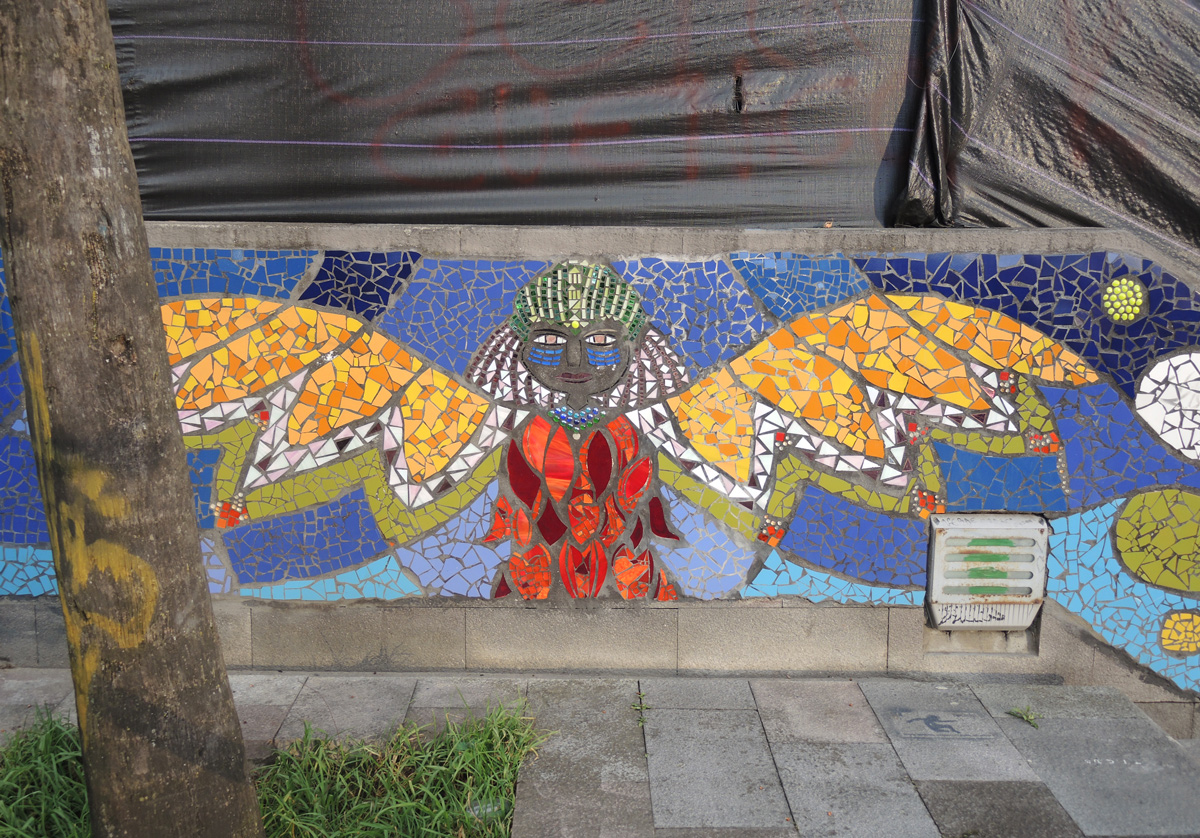 mosaic of a person with bridght yellow wings