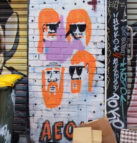 stencils of four people's heads with bright orange hair
