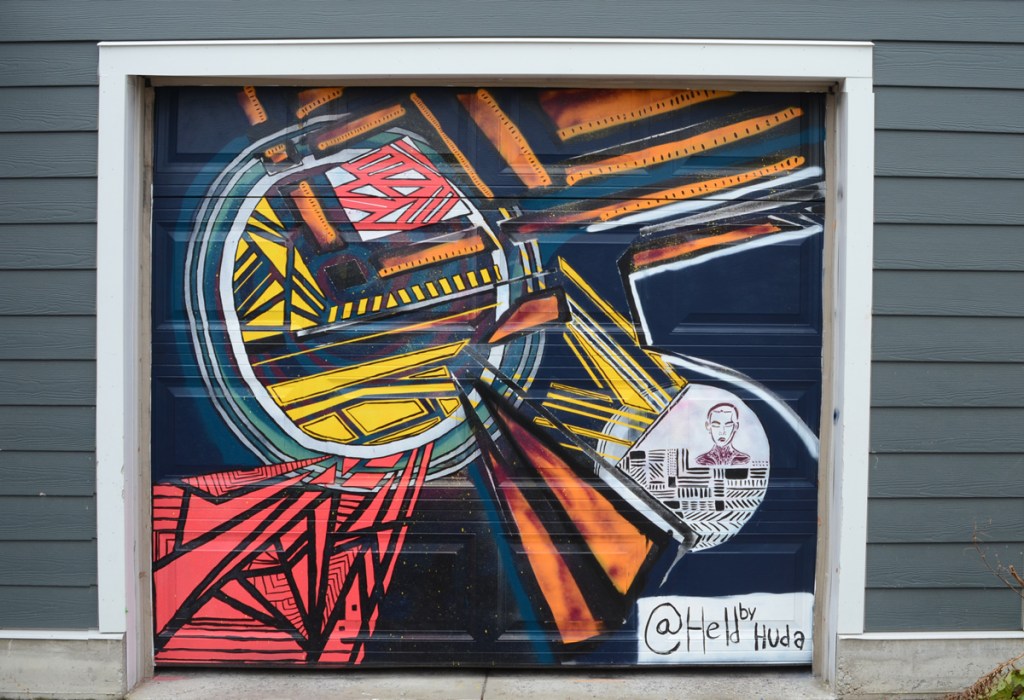 geometrics and shapes, abstract street art mural on a garage door by artist with instagram handle heldbyhuda