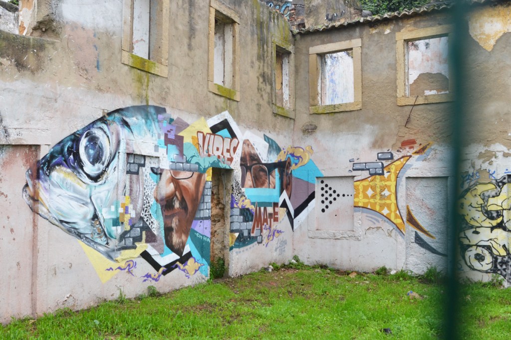 a mural of a large fish parts are realistic and parts are collages of other images including a mans face