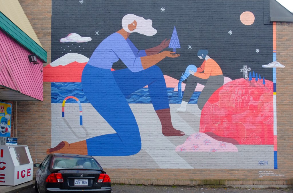muraal on a brick wall, two women working outside.  One is planting a blue pine tree and the other is pouring water, ther is a cross on a red hill with other blue trees on it. 