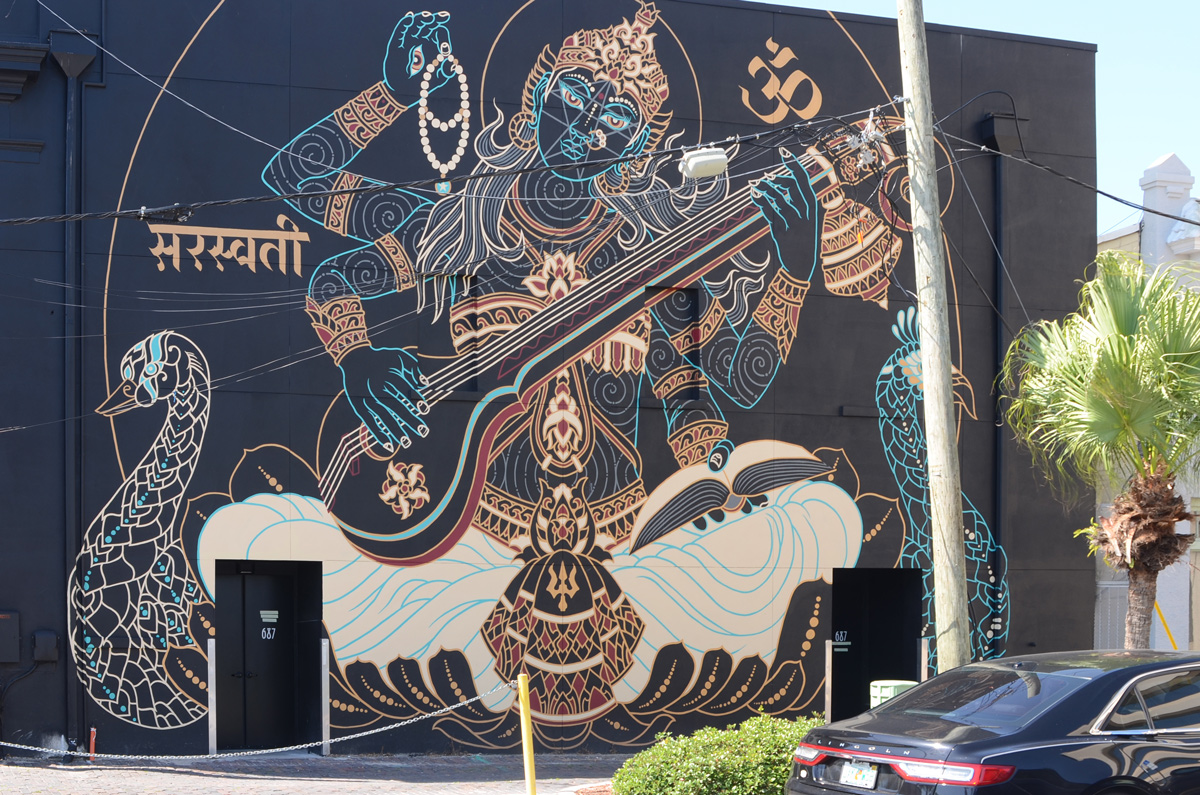 large 50 foot by 30 foot mural by Palehorse Design of the Hindu goddess saraswati playing a musical instrument called a veena.  She has four arms to represent the four elements of inner life, mind, intellect, ego, and consciousness. 