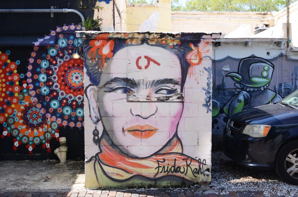 a small mural on the side of a garage, portrait of Frida Kahlo