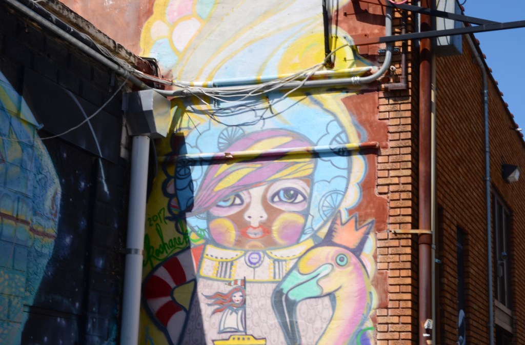 female figures with very decorated clothing, painted in a mural