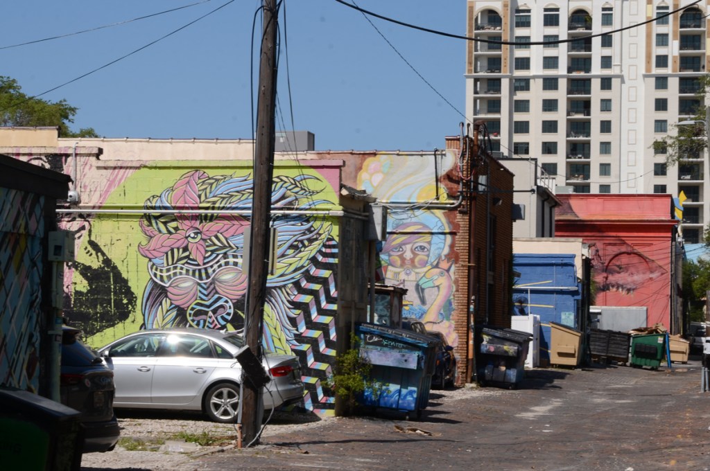 street art and murals painted on walls and buildings in an alley