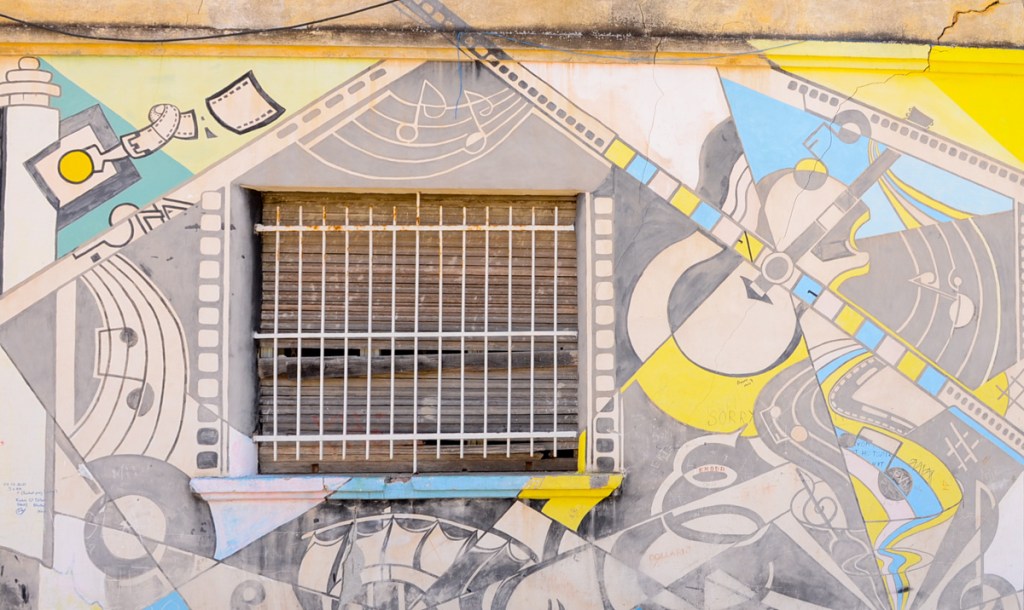 abstract mural around a window with a musical theme - a guitar, some music notes, treble clef