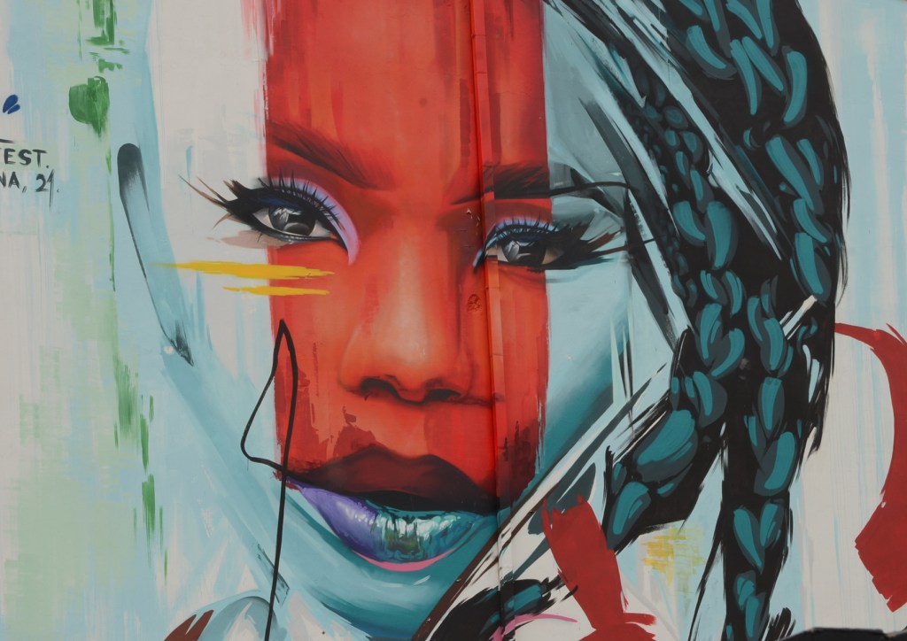 close up of woman's face in portrait by manomatic, mural