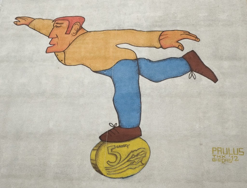 exterior mural of a man balancing on one foot on a coin on edge