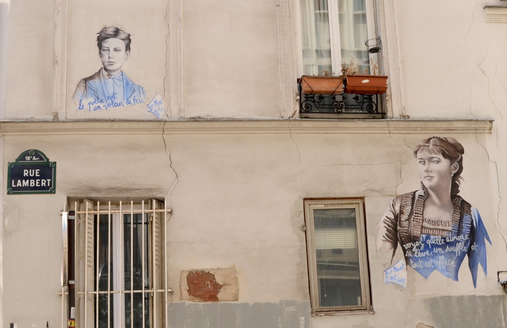 two portraits, with text, on a wall on rue Lambert in Paris, one male and one female, both by Jean Marc Paumier 