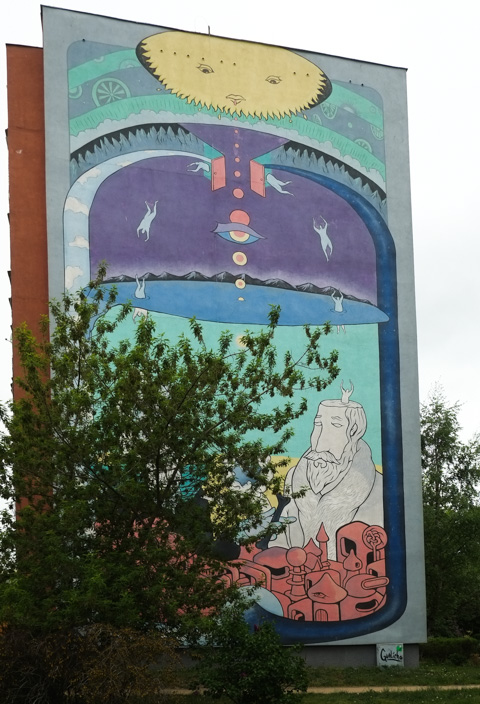 large mural on the side of an apartment block