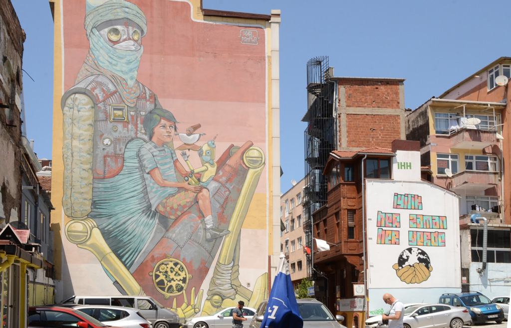 large mural in Kadikoy Istanbul painted by pixel pancho of a boy being held by an imaginary creature