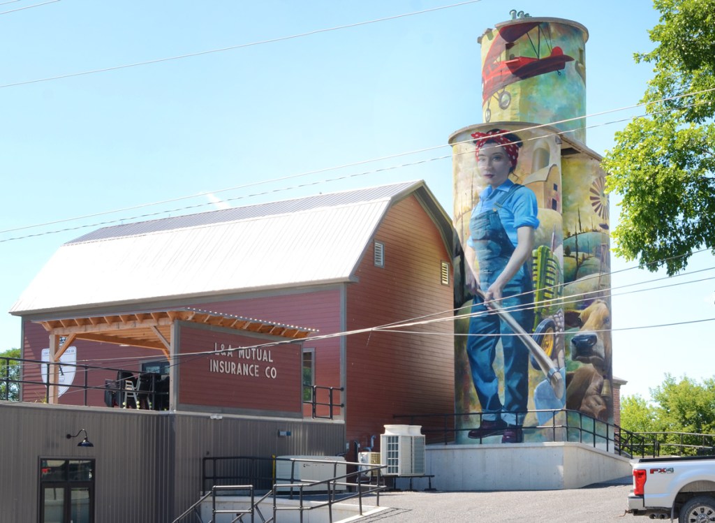 L & A Mutual insurance building in Napanee, once the County Depot with silos for storage. silos have been painted with farm scene