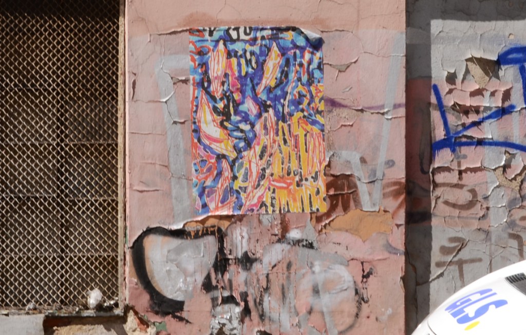 abstract painting on paper that was pasted to wall and is not peeling and fraying at the corners, in blues, yellows and reds