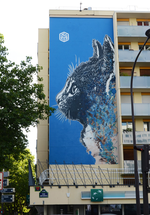large mural of a black cat's head, in profile