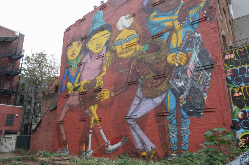 Osgemeos mural hip hop homage on 14th street in New York city, young people with ghetto blasters playing music and dancing 