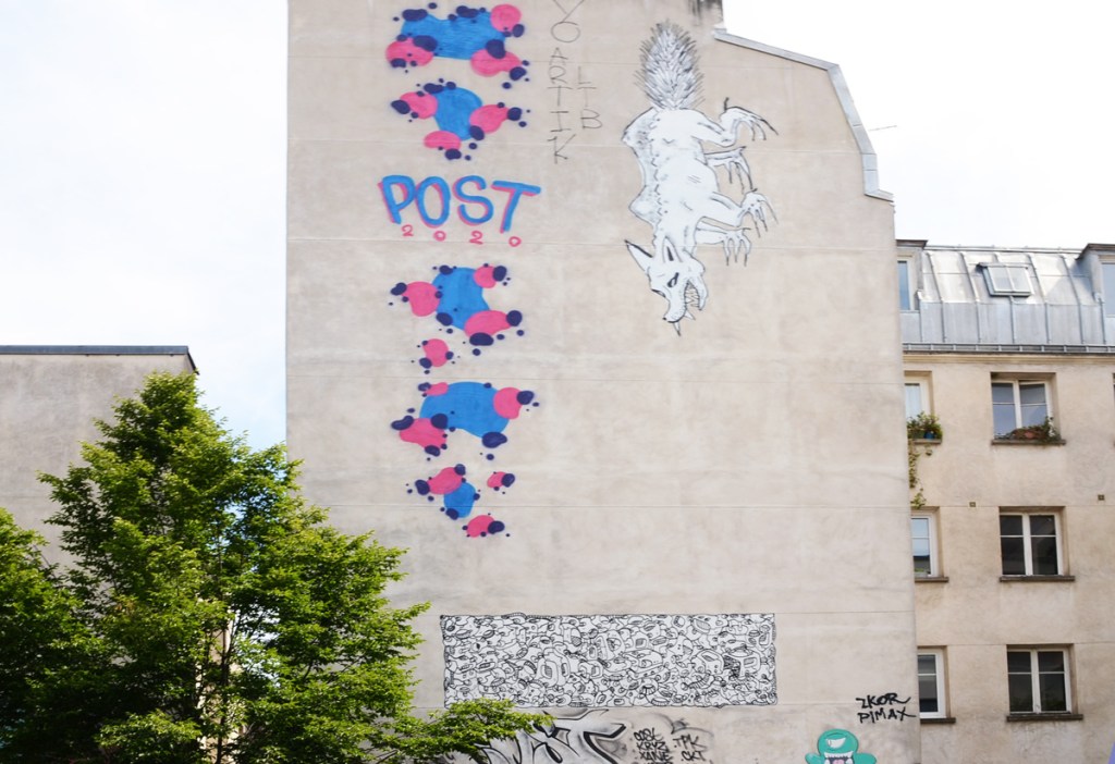 high on the side of a residential building, a black line drawing of a wolf with fangs, as well as blobs by POST painted in 2020