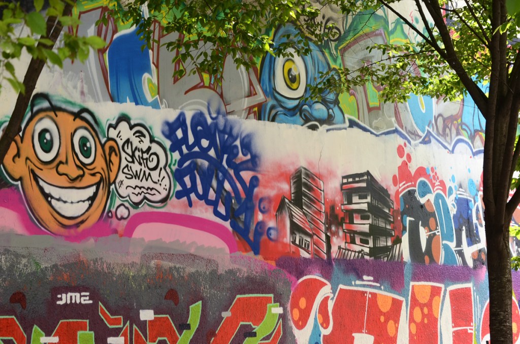 evidence of at least three layers of different street art