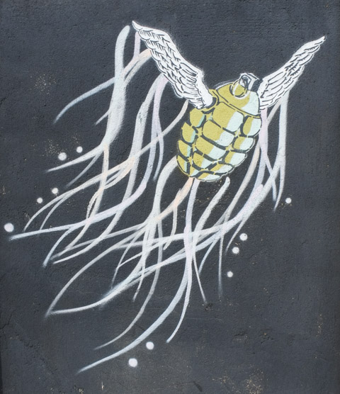 black and white image graffiti of a jelly fish-like creature with body of a hand grenade and small wings