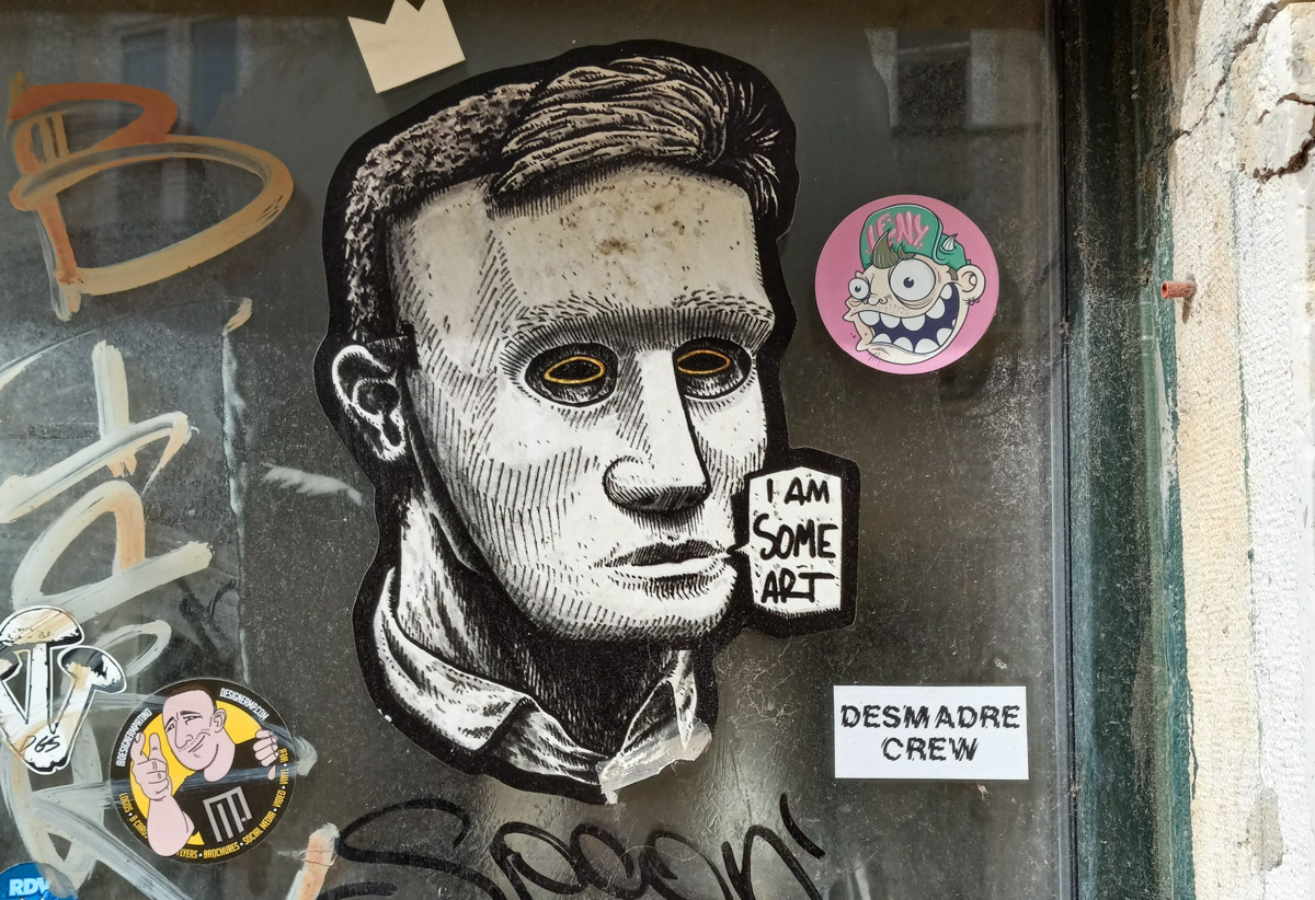 black and white wheatpaste paste up graffiti of a man's face