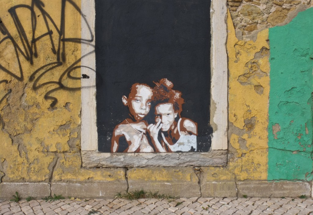 wheatpaste paste up image of two children sitting together and looking out the window