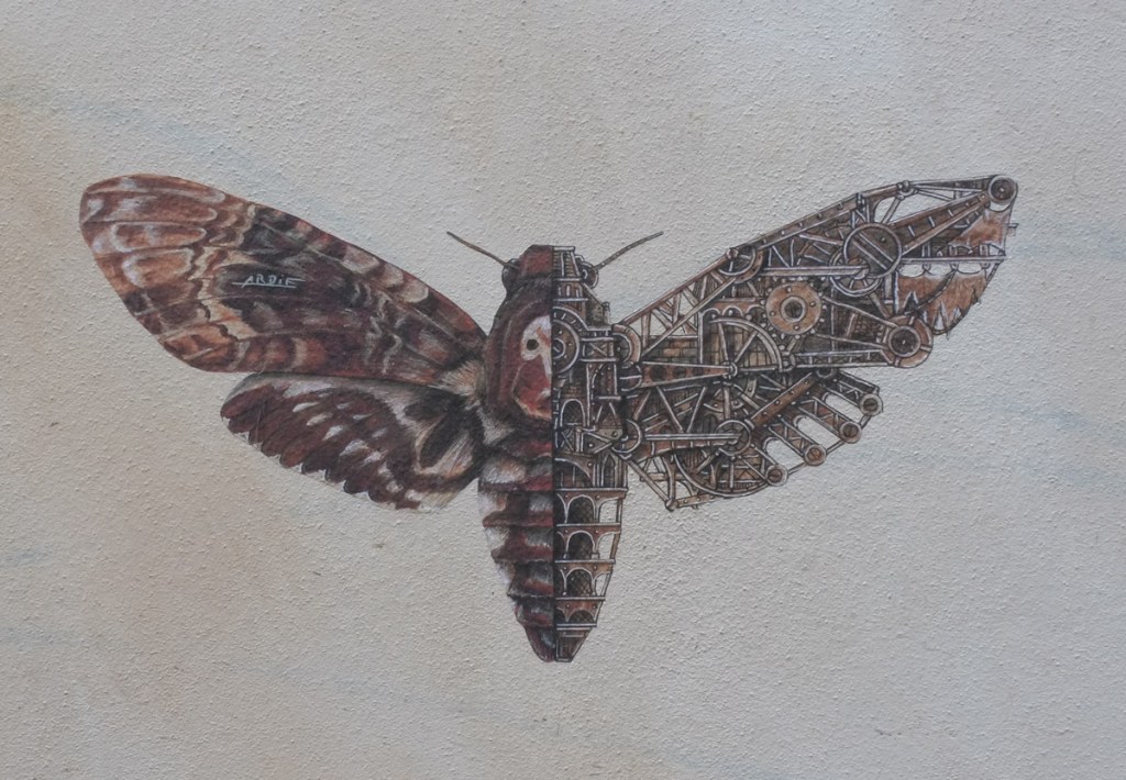artwork on outdoor wall, intricate painting of a moth in browns and blacks, one sign is very realistic, and the other side shows detailed mechanics, cogs and gears and levers and such