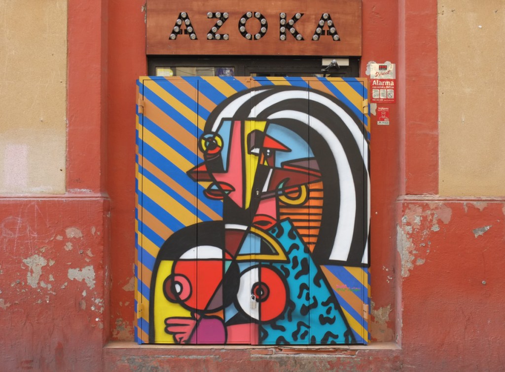 street art mural on metal shutters over windows of Akoda Taberna on Carrer de Blesa, painting of a woman, very abstract like a Picasso