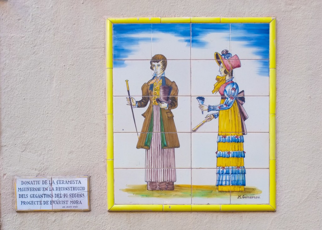 picture made from ceramic tiles of two giant figures, the giants of pi, one male and one female