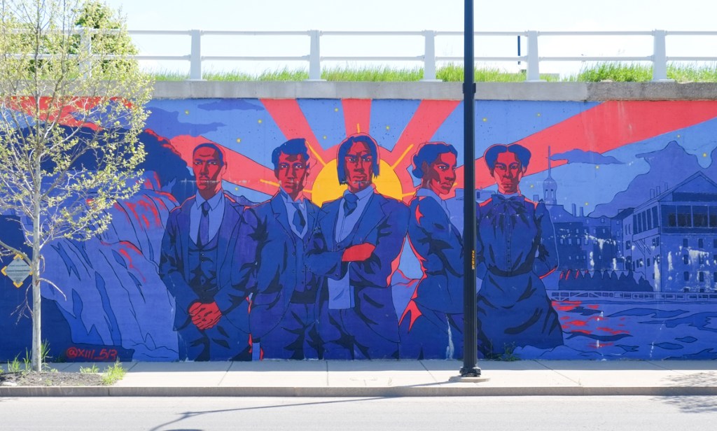 mural, men standing in front of a house