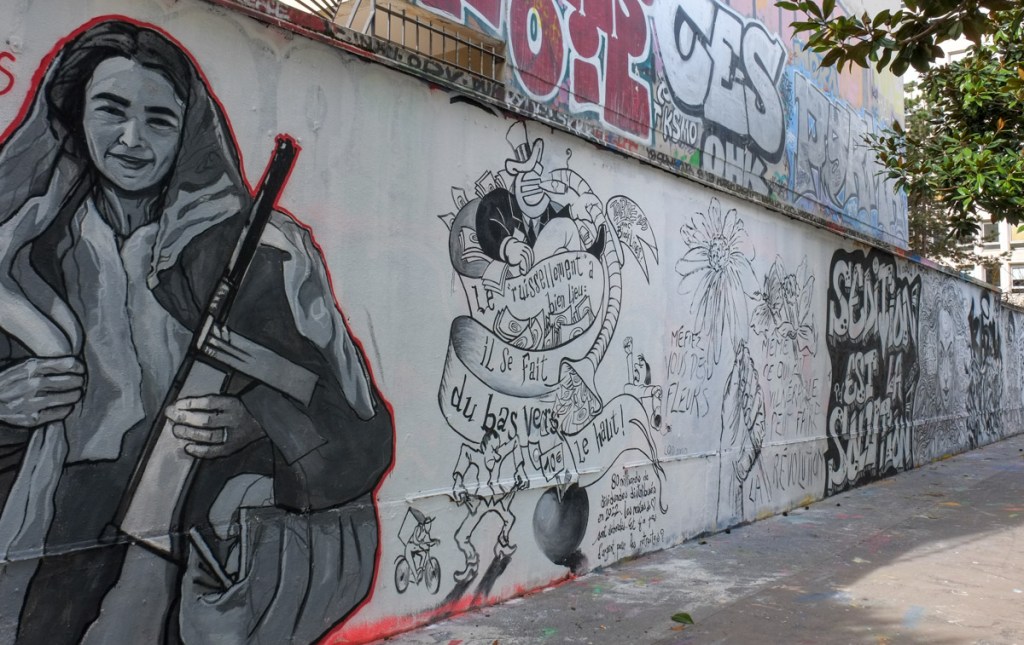 4 black and white paintings on a wall on rue Henri Nogueres, by Black Lines artist collective