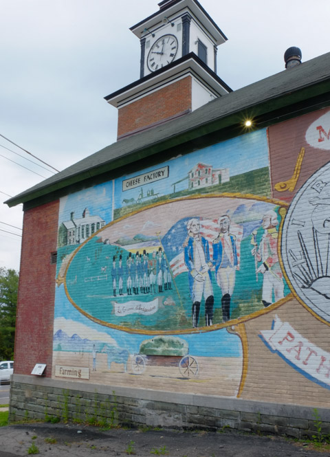 front end of town hall showing clock tower and part of mural