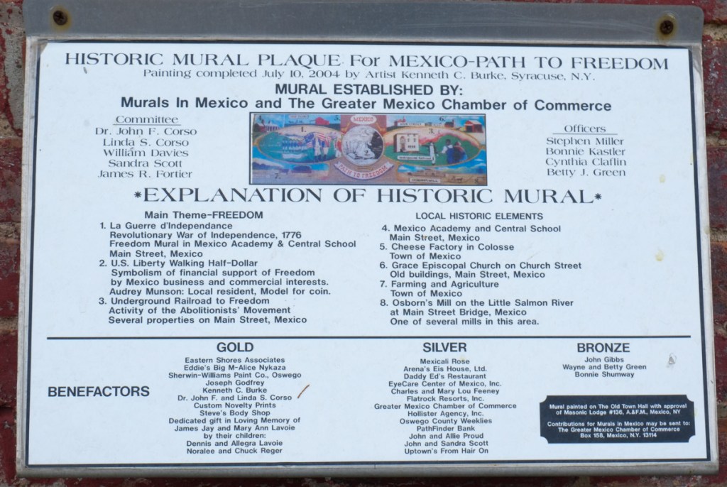 plaque beside a mural