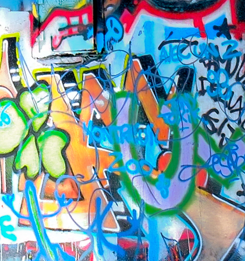 graffiti close up, wall, including scribbles and a green four leaf clover