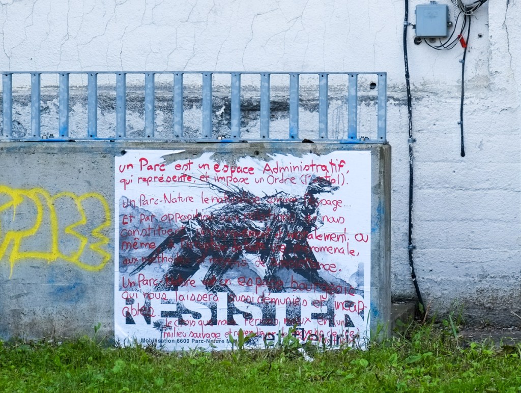 graffiti, all text, largest word is resister in black, lots of words in red too