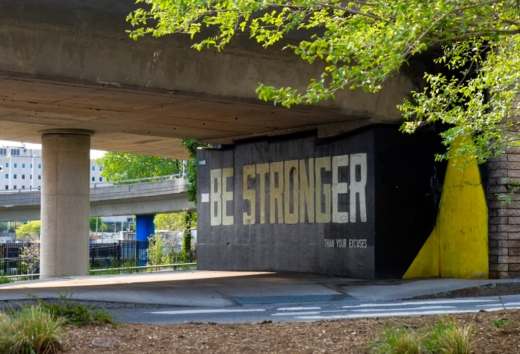 text mural that says be stronger than your excuses