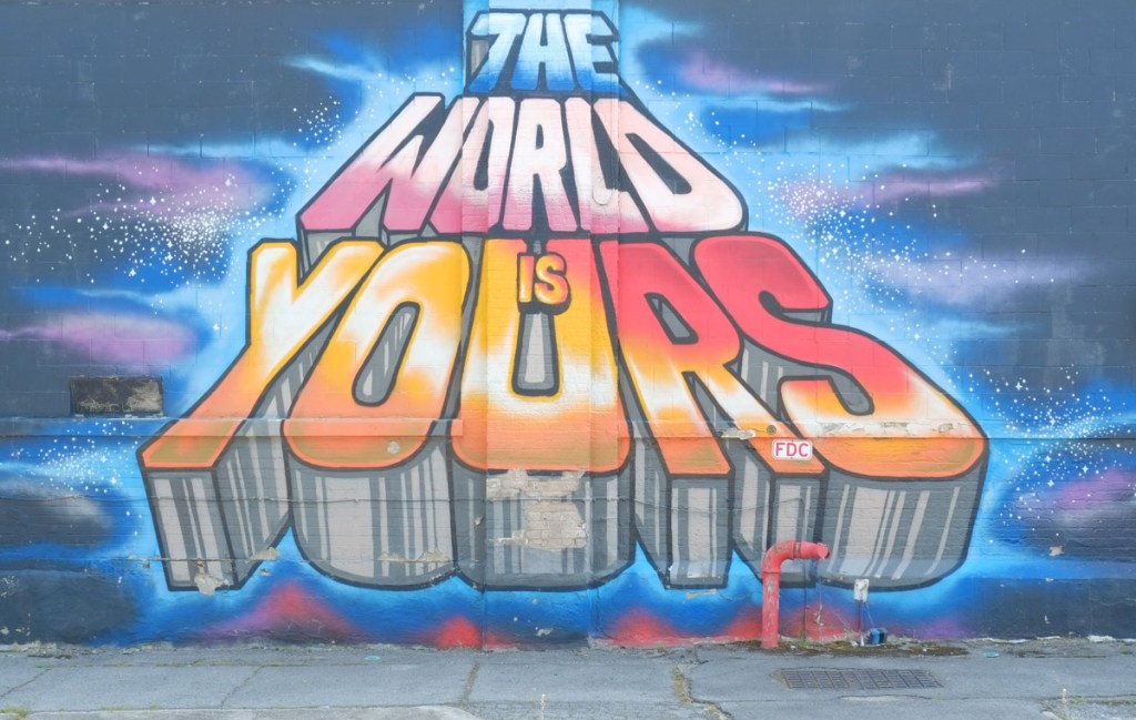 mural with text, the world is yours