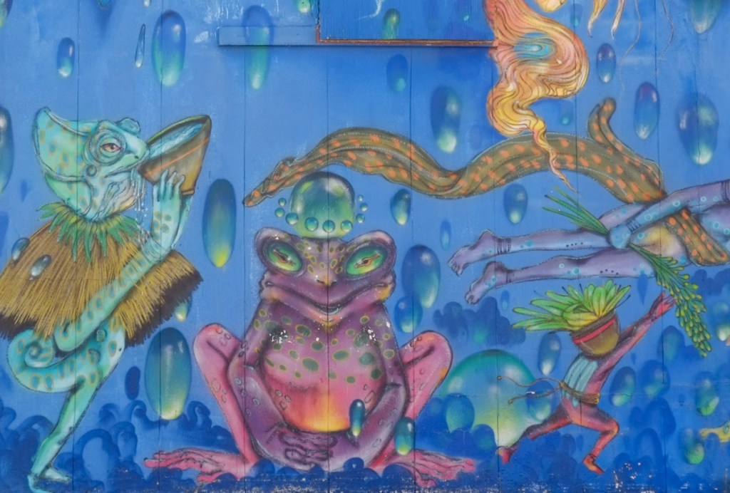 part of a mural with fantasy animals, a purple frog, a blue spotted iguana,