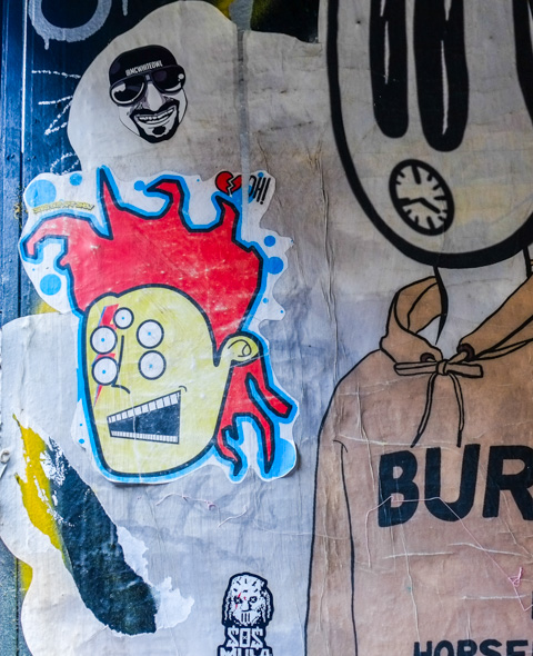 sticker by Sold Out Art Show, picture of a man with 5 eyes, flaming red hair