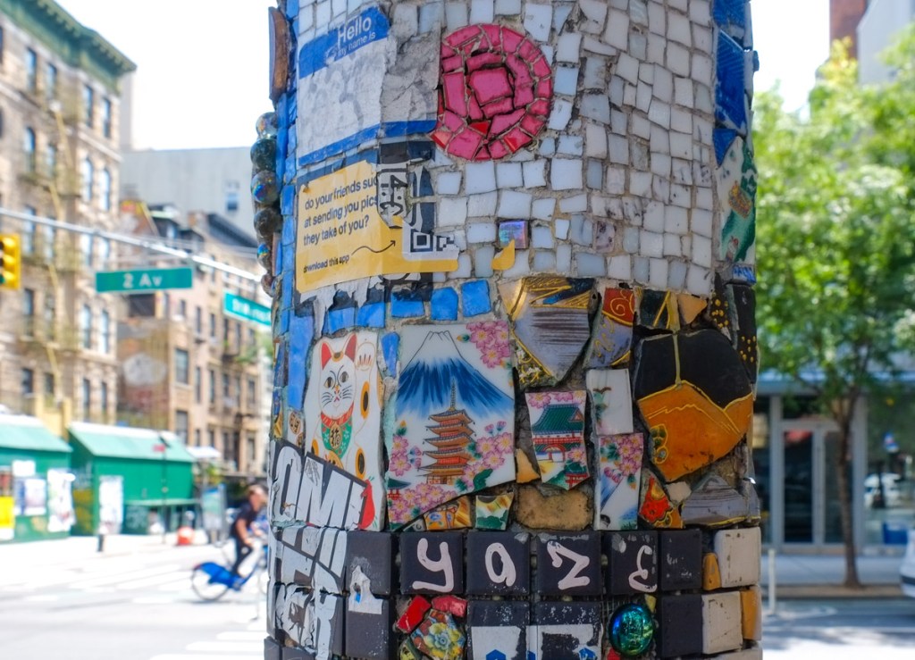 mosaics on outdoor street lamp posts, East Village mosaic trail, some pieces of broken ceramics have Japanese theme images on them