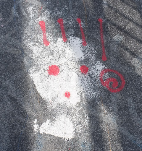 graffiti on pavement, white face with large red exclamation marks on it, dots of exclamation marks make the eyes