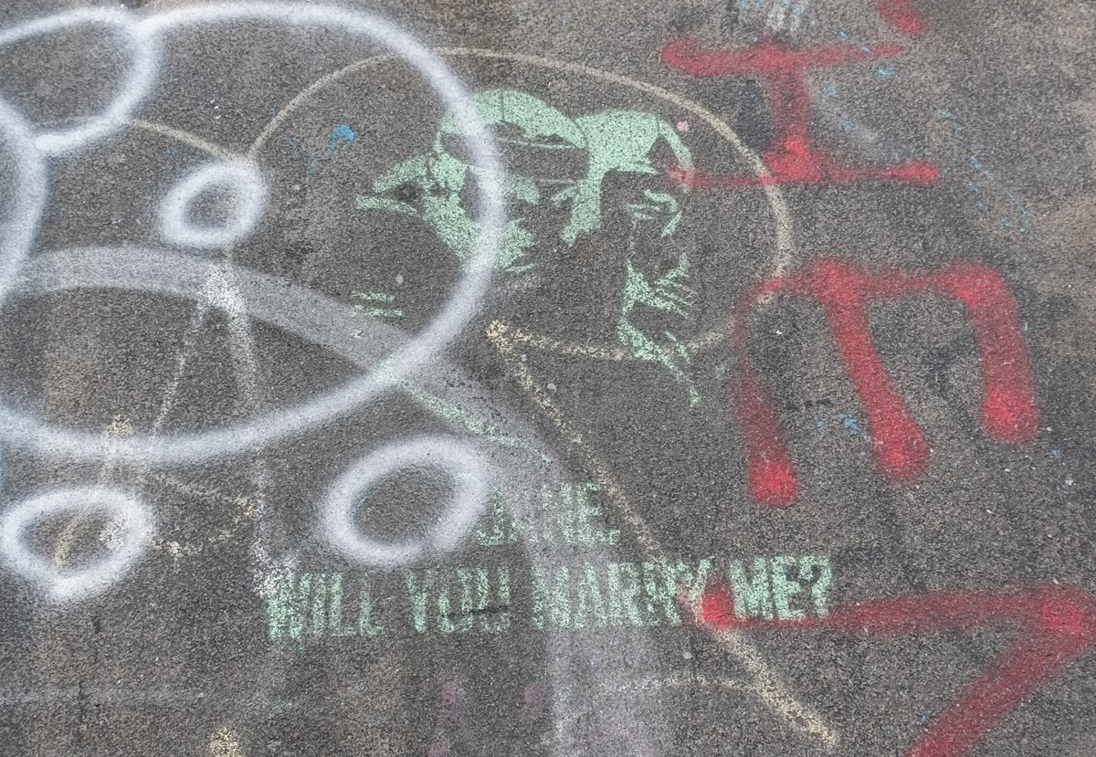 stencil graffiti with text that says Jane will you marry me