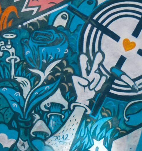 part of a mural with a pink heart, blue arm and hand