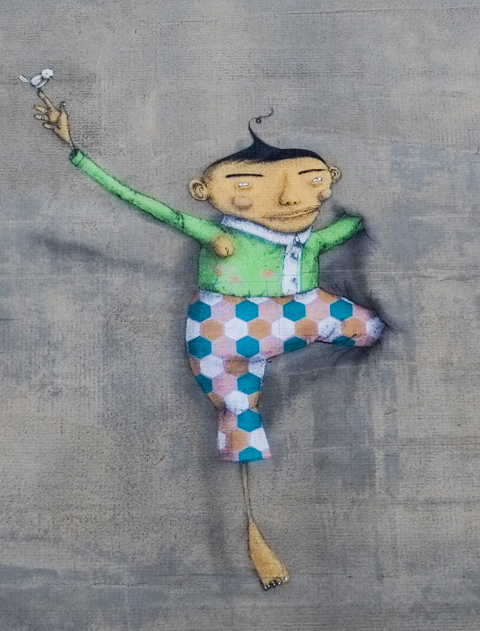 small man in a mural, looks like one leg and one arm is coming out of the wall