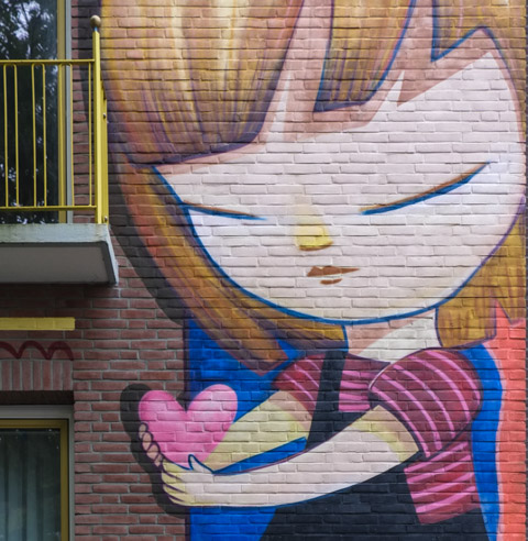part of a large mural by  Julieta XJF, a girl with bangs (hair fringe) is holding a little pink heart