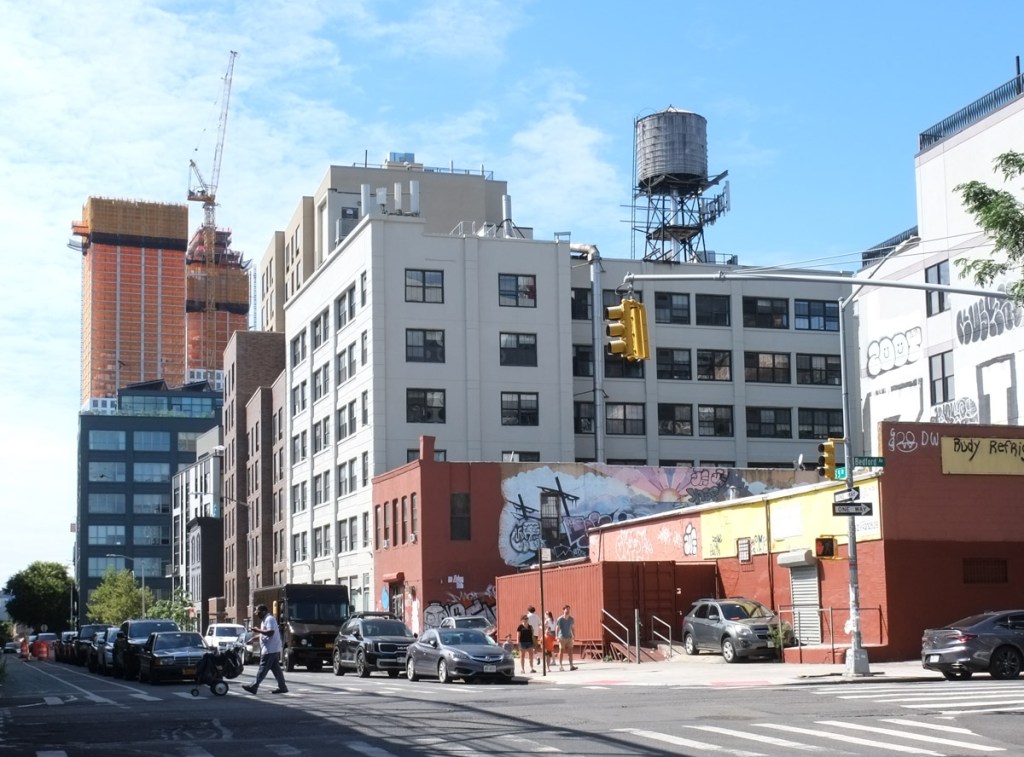 Williamsburg street sccene, mid rise buildings, traffic, water tower on roof, 